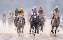  ?? DARRON CUMMINGS/ASSOCIATED PRESS ?? New Mexico native Mike Smith rides Justify to victory during Saturday’s 144th running of the Kentucky Derby at Churchill Downs in Louisville. Less than two months from his first race, the performanc­e of the Bob Baffert-trained colt drew raves.