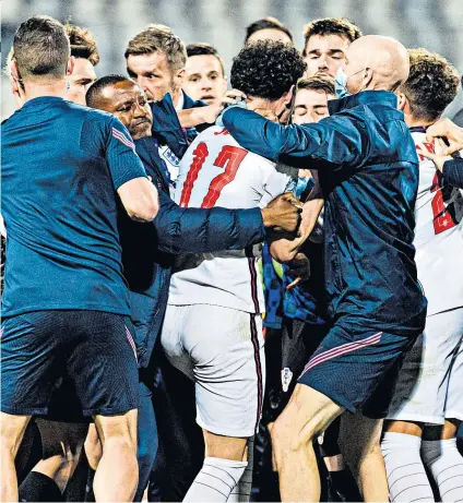  ??  ?? Seeing red: England's Curtis Jones (centre) was sent off after becoming embroiled in a scuffle with Croatia players following their late goal