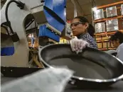  ?? Chronicle file photo ?? Tramontina assembly worker Albertina Del Valle assembles cooking pans in Sugar Land.