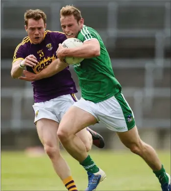  ??  ?? Wexford’s Kevin O’Grady tries to stop Limerick midfielder Darragh Treacy launching an attack.