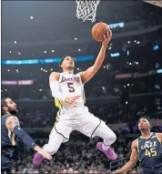  ?? MARK J. TERRILL — THE ASSOCIATED PRESS ?? Lakers guard Josh Hart shoots as Utah’s Ricky Rubio, left, and guard Donovan Mitchell look on helplessly.