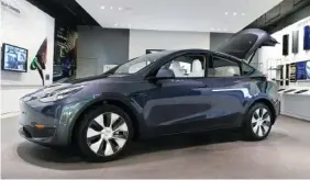  ?? AP FILE PHOTO/CARLOS OSORIO ?? A Tesla Model Y Long Range is displayed in late February at the Tesla Gallery in Troy, Mich.