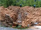  ??  ?? POLICE PROTECTION: Police officers guard the site of a proposed Hindu temple in Islamabad. — AP file