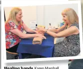  ??  ?? Healing hands Karen Marshall gets a hand massage from Eunice Sneddon