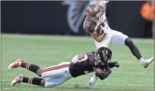  ?? Chris O’Meara / AP ?? Atlanta free safety Damontae Kazee (left) takes down Tampa Bay wide receiver Adam Humphries during the second half Sunday in Atlanta.