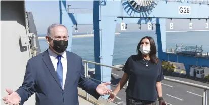  ?? ( Koby Gideon/ GPO) ?? PRIME MINISTER Benjamin Netanyahu and Transporta­tion Minister Miri Regev visit the Haifa Port yesterday where a container ship from the UAE docked.