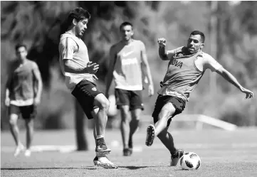  ??  ?? Carlos Tevez (right) of Argentina’s Boca Juniors in action with Pablo Perez during a training session at the Los Cardales complex, in the outskirts of Buenos Aires, Argentina in this Jan 9 file photo. — Reuters photo