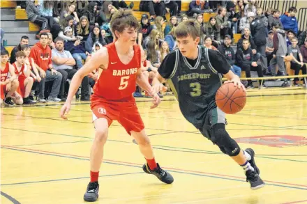  ??  ?? The Barrington Barons’ Doug Symonds (#5) tries to block Lockeport’s Avery Lloyd as he breaks down the court in the opening game of the BMHS Junior Boys Winter Classic Basketball Tournament. KATHY JOHNSON PHOTOS