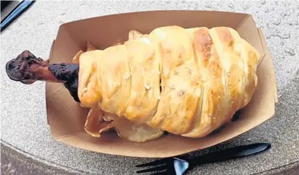  ?? PHOTOS BY DEWAYNE BEVIL/STAFF ?? SeaWorld Orlando has a $14.99 pretzel-covered turkey leg at Mama’s Pretzel Kitchen.