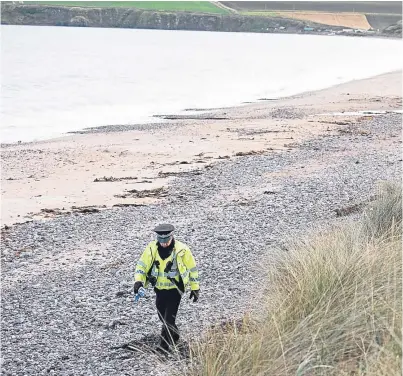  ?? Picture: Andy Thompson. ?? Police officers cordoned off the beach and dunes at Lunan Bay and were awaiting the army bomb disposal team following the discovery of a number of wartime devices.