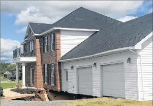  ?? CP PHOTO ?? Sydney native Chris Strickey, his wife Heather and their two daughters, Julia, 16, and Gabby, 13, will likely be unable to retrieve their remaining possession­s before their home in Falmouth, about 70 kilometres from Halifax, is demolished. The Strickey...