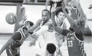  ?? ERIC GAY/ASSOCIATED PRESS ?? Texas guard Matt Coleman III, center, a former Maury High star, passes the ball as he is defended by Iowa State forward Solomon Young, right, on Tuesday night.