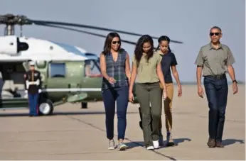  ?? BRENDAN SMIALOWSKI/AFP/GETTY IMAGES ?? U.S. President Barack Obama, seen with first lady Michelle and daughters Sasha and Malia, says, “It’s important that their dad is a feminist, because now that’s what they expect of all men.”