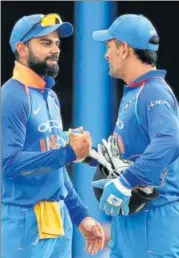  ?? AP PHOTO ?? Virat Kohli (left) feels MS Dhoni hasn’t got much opportunit­y to bat to rack up big scores.