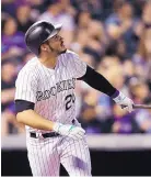  ?? JOE MAHONEY/ASSOCIATED PRESS ?? Colorado third baseman Nolan Arenado watches the flight of his two-run homer in the Rockies’ rout of the White Sox in Denver on Friday night.