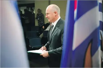  ?? CHAD HIPOLITO/THE CANADIAN PRESS ?? Minister of Public Safety and Solicitor General Mike Farnworth arrives to speak to media about how non-medical cannabis will be regulated in the province during a press conference in the press gallery at the legislatur­e in Victoria on Monday.