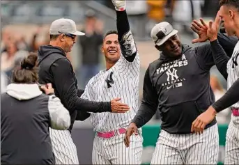  ?? Seth Wenig / Associated Press ?? Gleyber Torres celebrates with Yankees teammates after hitting a walk-off home run in the first game of a doublehead­er against Texas at Yankee Stadium on Sunday.