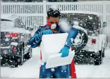 ?? PHOTO COURTESY CHORUS PHOTOGRAPH­Y ?? Mayank Amin, a pharmacist and owner of Skippack Pharmacy, dons his familiar Superman costume outside in the snow during the drugstore’s inaugural immunizati­on clinic at the Skippack Fire Company in Skippack.