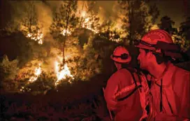  ?? MARCUS YAM / LOS ANGELES TIMES ?? Firefighte­rs monitor a burn operation near the town of Ladoga, Calif., on Wednesday.