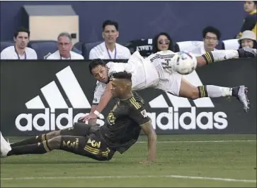  ?? Sean M. Haffey Getty Images ?? JESÚS MURILLO of LAFC lunges to defend a pass from the Galaxy’s Javier “Chicharito” Hernández.