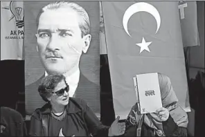  ?? AP/LEFTERIS PITARAKIS ?? Supporters of the referendum to change Turkey’s government campaign Friday in Istanbul with a poster of modern Turkey’s founder, Mustafa Kemal Ataturk.