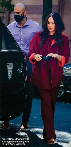  ?? ?? Protection: Meghan with a bodyguard during visit to New York last year