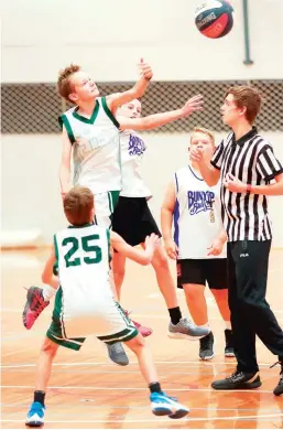  ?? ?? Rebels’ Ben Westwood and Bunyip’s Max Wouters fly for the opening tip off in the under 14AR2 game. Bunyip won 29-15.