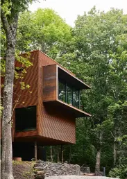  ?? ?? TOP: Perched on stilts, the weathering-steel house sits lightly on the land.