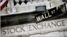  ?? MARK LENNIHAN — THE ASSOCIATED PRESS FILE ?? A Wall Street street sign outside the New York Stock Exchange is shown.