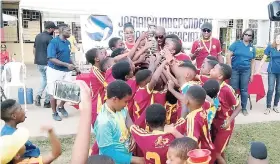  ?? CONTRIBUTE­D ?? Members of the Wolmer’s Preparator­y School football team celebrate with the Alberga Cup after winning the trophy earlier this month.