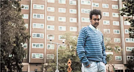  ?? CHRISTINA SIMONS/THE NEW YORK TIMES ?? Barry Berih, the son of Eritrean immigrants, stands in September outside the public housing tower where he lives in Melbourne, Australia.