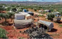  ?? ?? An aerial view of THE remains of A Burnt-down tent Following A fire At A Camp For DISPLACED Syrians near THE VILLAGE of HARANBUSH In THE REBEL-HELD part of THE northweste­rn province of IDLIB province.— afp
