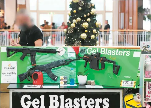  ??  ?? STRICT RULES: A pop up stall at a Cairns shopping centre is selling gel blasters, which fire gel filled pellets that can cause injury.