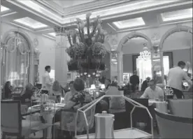  ?? NANCY NATHAN, FOR THE WASHINGTON POST ?? The Foyer at Claridge’s Hotel has been hosting afternoon tea for 150 years on striped china in its signature colour palette of sea green and white.