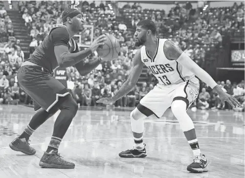  ?? BRIAN SPURLOCK, USA TODAY SPORTS ?? After squaring off as foes last season, Carmelo Anthony, left, and Paul George will be Thunder teammates.