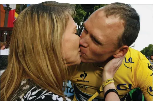  ??  ?? To the winner go the spoils: Tour de France champion Chris Froome gets a victory kiss from pregnant wife Michelle in Paris yesterday