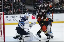  ?? RYAN SUN — THE ASSOCIATED PRESS ?? The Ducks' Jakob Silfverber­g (33) attempts a shot on Winnipeg goaltender Laurent Brossoit during the third period of Friday night's game at Honda Center.