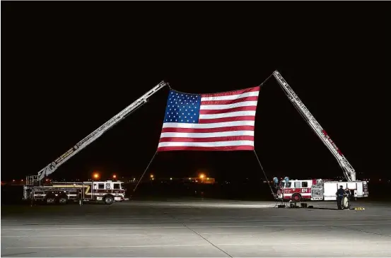  ?? Saul Loeb/AFP ?? Bandeira dos EUA é preparada para a chegada do avião com os 3 americanos libertados pela Coreia do Norte a uma base aérea perto de Washington