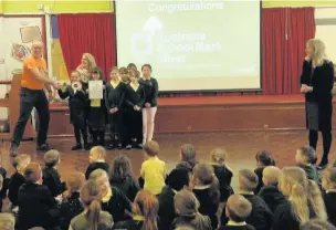  ??  ?? Pupils at Afon Y Felin Primary School in North Cornelly receive their Silver School Mark Award from Sustrans Cymru