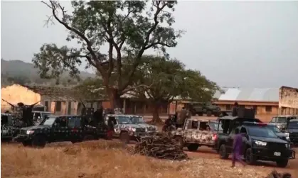  ?? ?? Nigerian army vehicles parked outside the school in Kuriga from where the children were kidnapped on Thursday. Photograph: AP Video/ AP