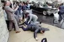  ?? Museum/AFP/Getty Images ?? A White House aide and a police officer lie wounded outside the Washington Hilton after the assassinat­ion attempt on Ronald Reagan in March 1981. Photograph: The Ronald Reagan Presidenti­al Library and