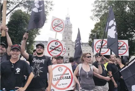  ?? JACQUES BOISSINOT/THE CANADIAN PRESS ?? La Meute supporters march in Quebec City on Aug. 20, 2017, a week after a protester was killed at a Unite the Right rally in Charlottes­ville, Va. — the largest white supremacis­t gathering in a generation — attended by a small, militant crew of Quebecers.