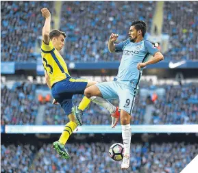  ??  ?? Seamus Coleman (left) and Ilkay Gundogan battle in the air.