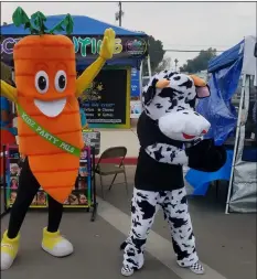  ?? COURTESY PHOTO ?? King Carrot and Moolicious breads’ cow engage in a mini dance-off at the midway at the 2019 Carrot Festival and Street Fair in Holtville.