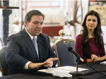  ?? IVY CEBALLO
Tampa Bay Times via AP ?? Florida Gov. Ron DeSantis answers questions as his wife, Casey DeSantis, listens following a roundtable discussion regarding mental health at the Tampa Firefighte­r Museum on Dec. 11, 2020.