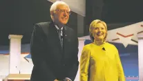  ?? ASSOCIATED PRESS FILE PHOTO ?? Democratic presidenti­al candidates Sen. Bernie Sanders, I-Vt., left, and Hillary Clinton smile before a 2016 Democratic presidenti­al primary debate in Milwaukee. A group called New Democracy is trying to reimagine the brand in regions where Democrats...