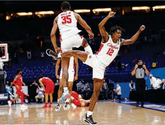  ?? Jamie Squire / Getty Images ?? Tramon Mark, front, celebrates with Fabian White Jr. after edging Rutgers on Sunday in the second round. Mark scored the go-ahead points to seal the win.