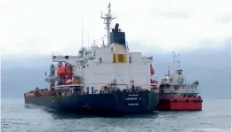  ?? — PTI ?? A cargo vessel, Amber (left), is detained by coastal security agencies for allegedly hitting a fishing boat, Carmel Matha, near the Kochi coast on Sunday.