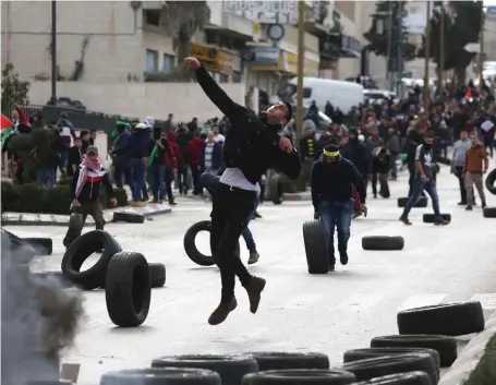  ?? Getty ?? Palestinia­n protesters clash with Israeli forces in the West Bank yesterday after Donald Trump’s announceme­nt on Jerusalem