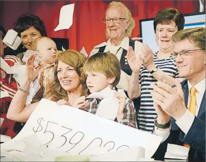  ?? MITCH MACDONALD/THE GUARDIAN ?? QEH/Eastlink Telethon host Marlene MacDonald, left, celebrates with her nephew, Jack Pereira, and QEH Foundation chair Bob Sear, as well as a number of volunteers, after raising $539,089 during the annual event this weekend. The funds raised will go...